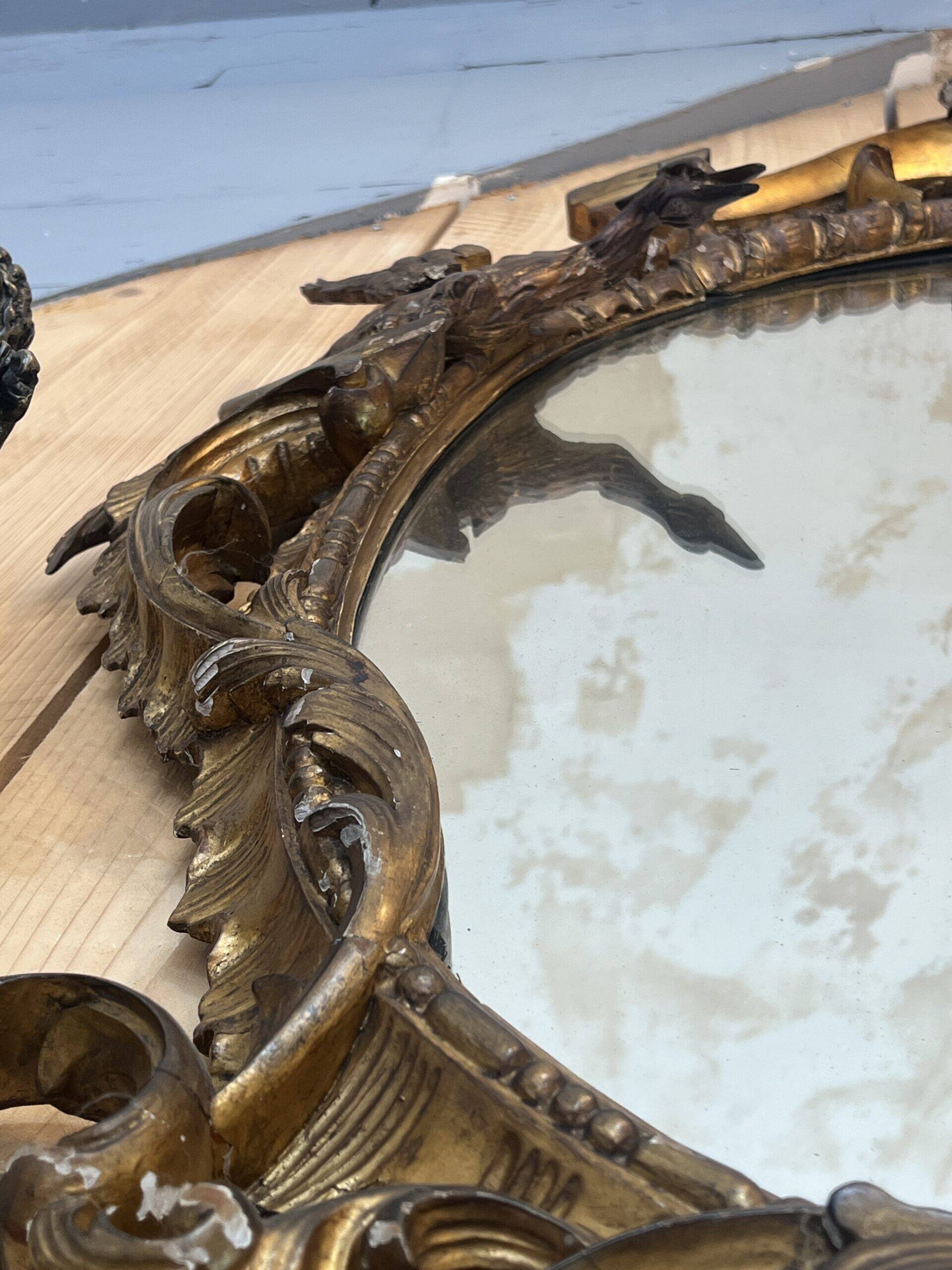 Large gilded wooden mirror, richly carved with winged dragons, 19th century