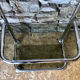 Chromed metal shelf and smoked glass
