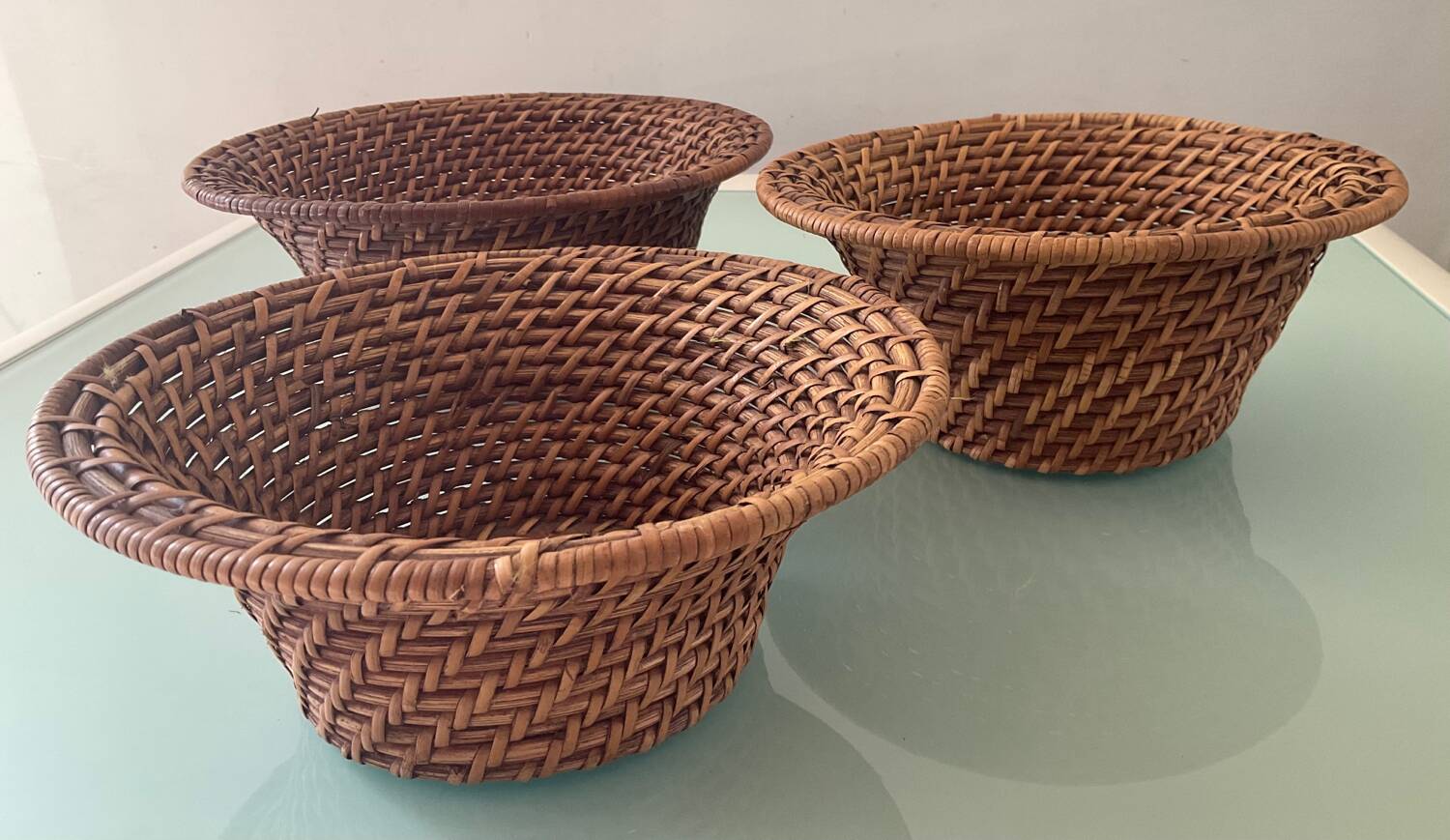 Trio of vintage woven rattan and wicker baskets