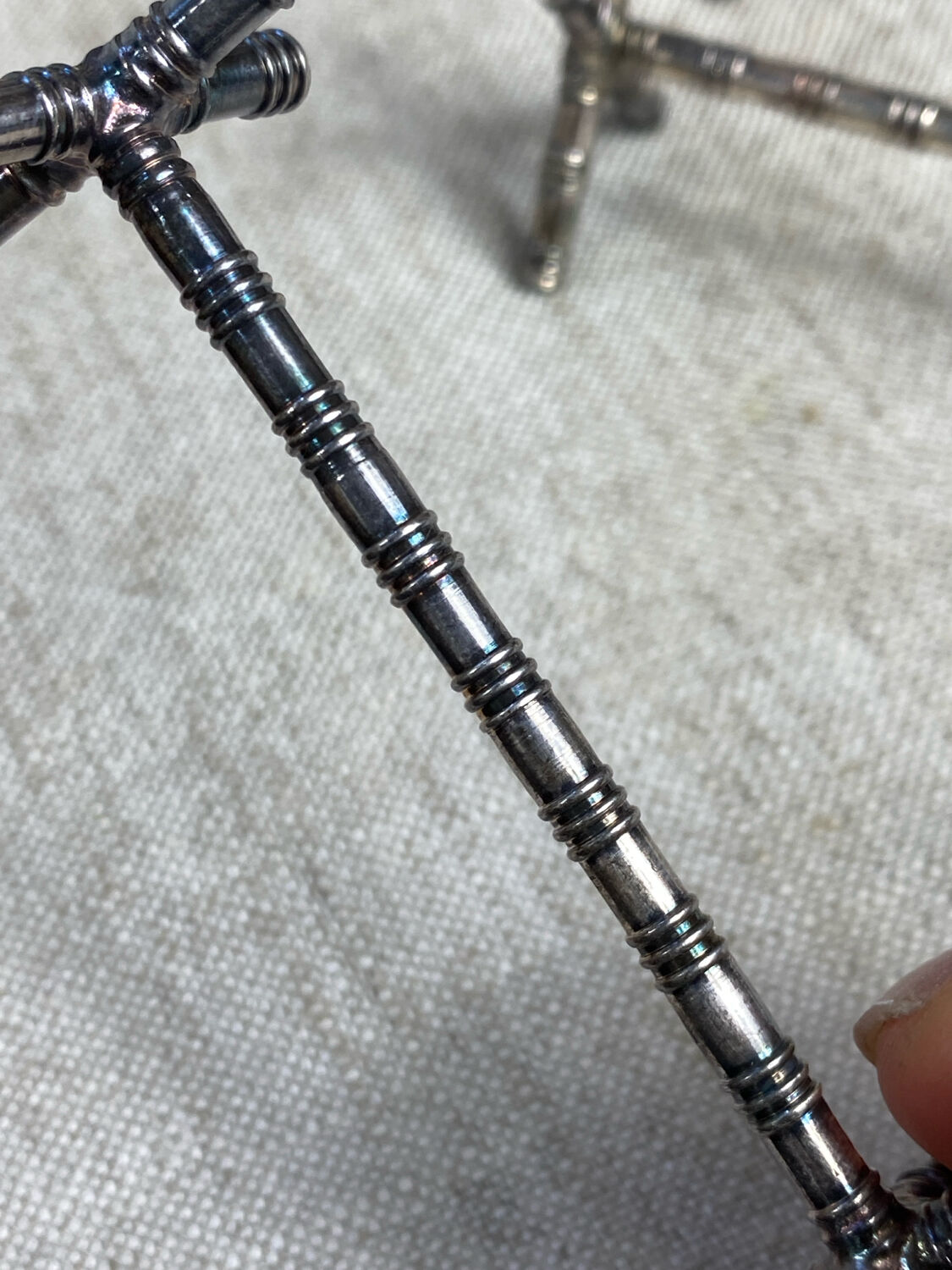 Six bamboo-patterned metal silver-plated knife rests.