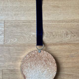 Vintage witch's eye curved mirror hangs velvet ribbon