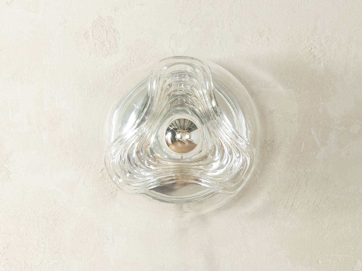 Sculptural wave wall lamp made of structured solid glass by peill & putzler