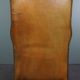 Old wingback armchair made of sheep leather in a correct condition