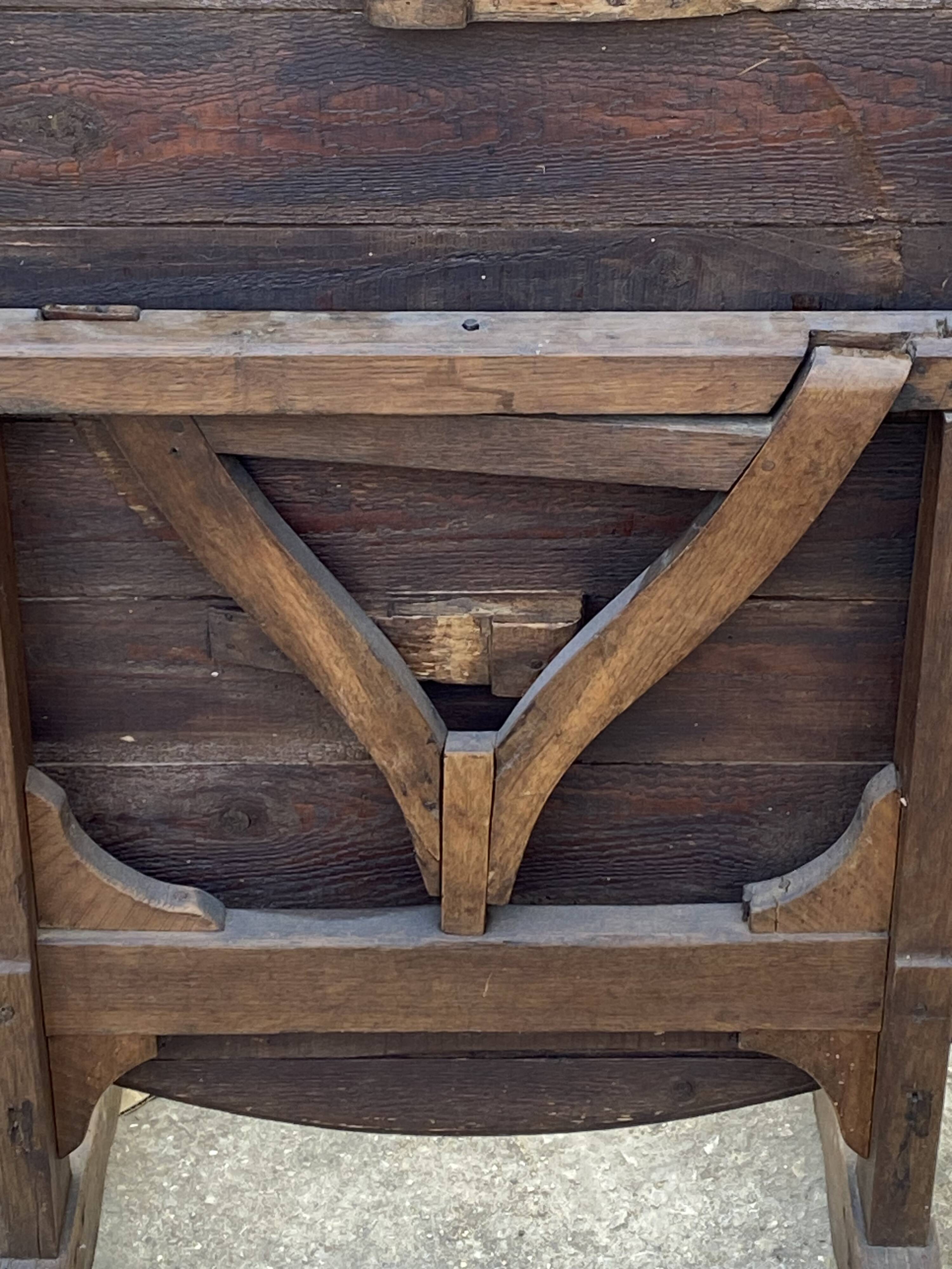 Old folding round winemaker's table with a tilting top.