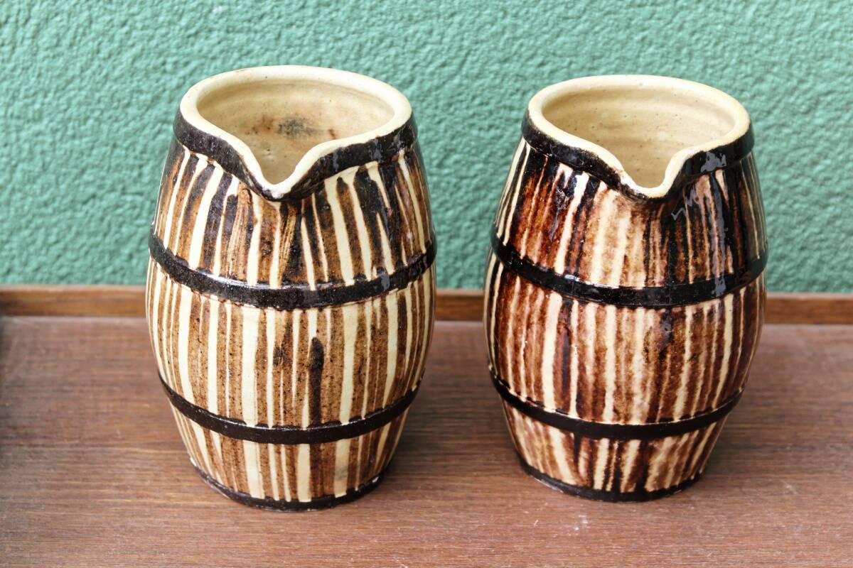 Pair of trompe l'oeil bistro pitchers, barrels