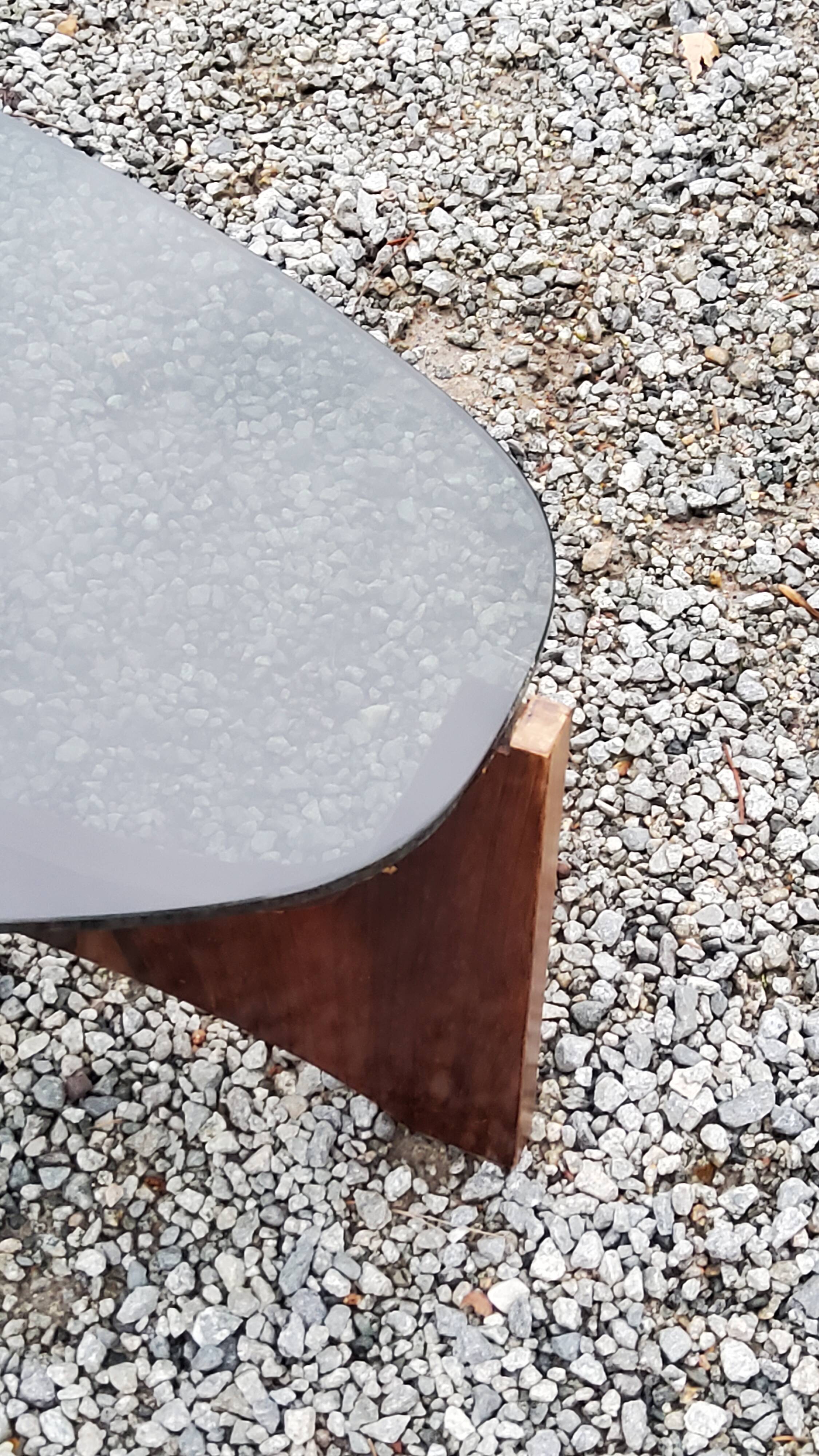 Designer coffee table by Hugues Poignant in rosewood and smoked glass from the 70s