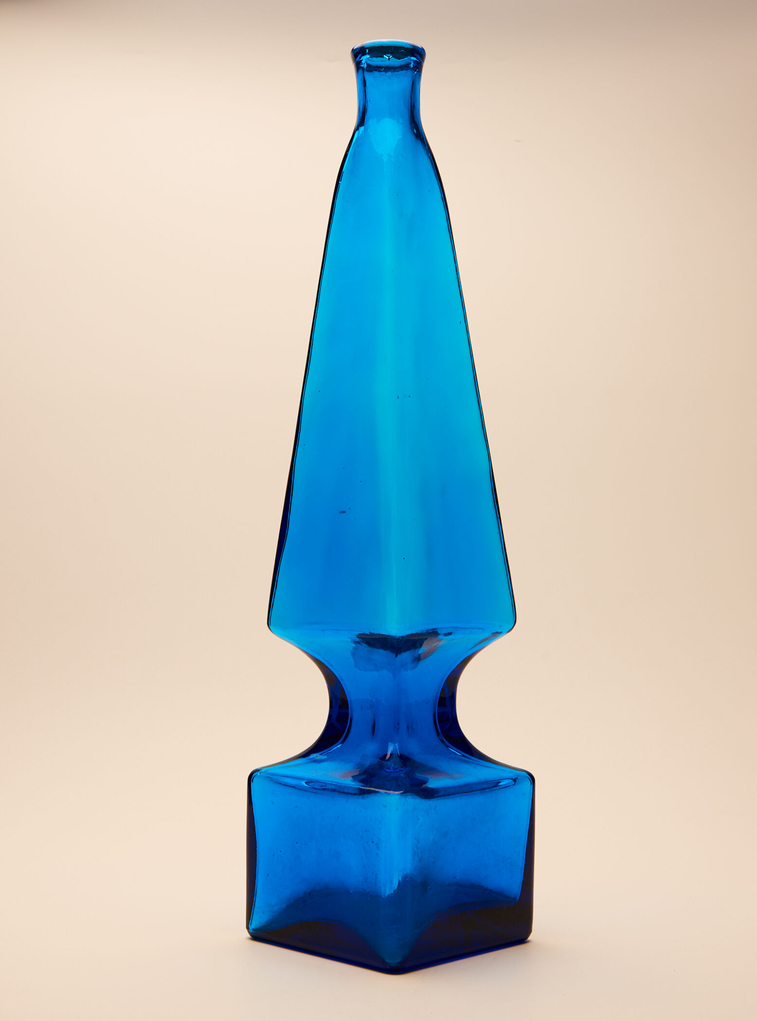 large blue glass obelisk-shaped bottle or vase