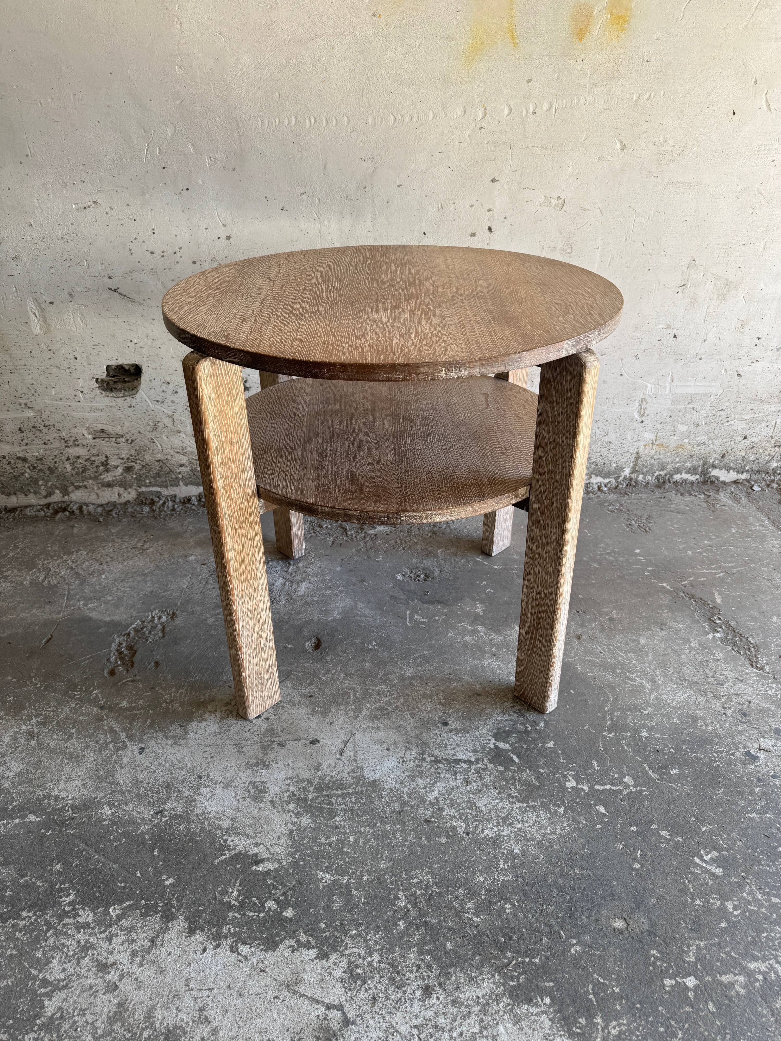 Art Deco round oak side table in light weathered oak with lower shelf, geometric three-leg design