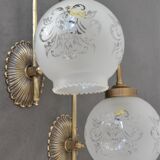 Pair of engraved glass wall lamps, brass support