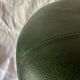 Pouf vintage rond en Skaï vert