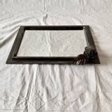 Vintage wall mirror in varnished steel decorated with a rose in relief