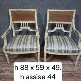 a pair of caned armchairs in the Louis XVI style, elegant and full of charm.