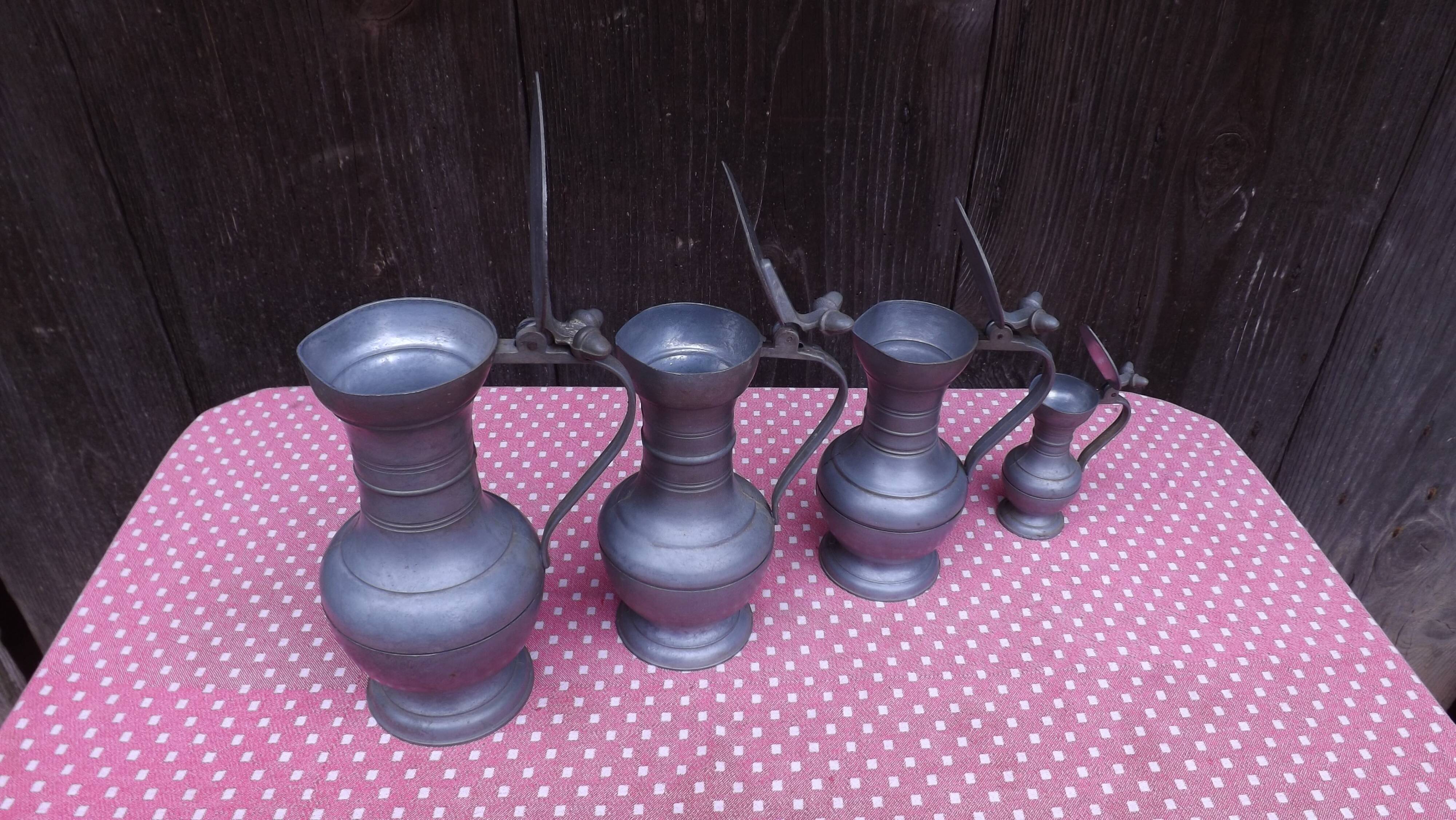 Lot of 4 tin pitchers