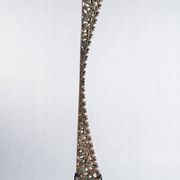 Indonesian construction element in carved wood with intertwined plant motifs mounted on a base (fri