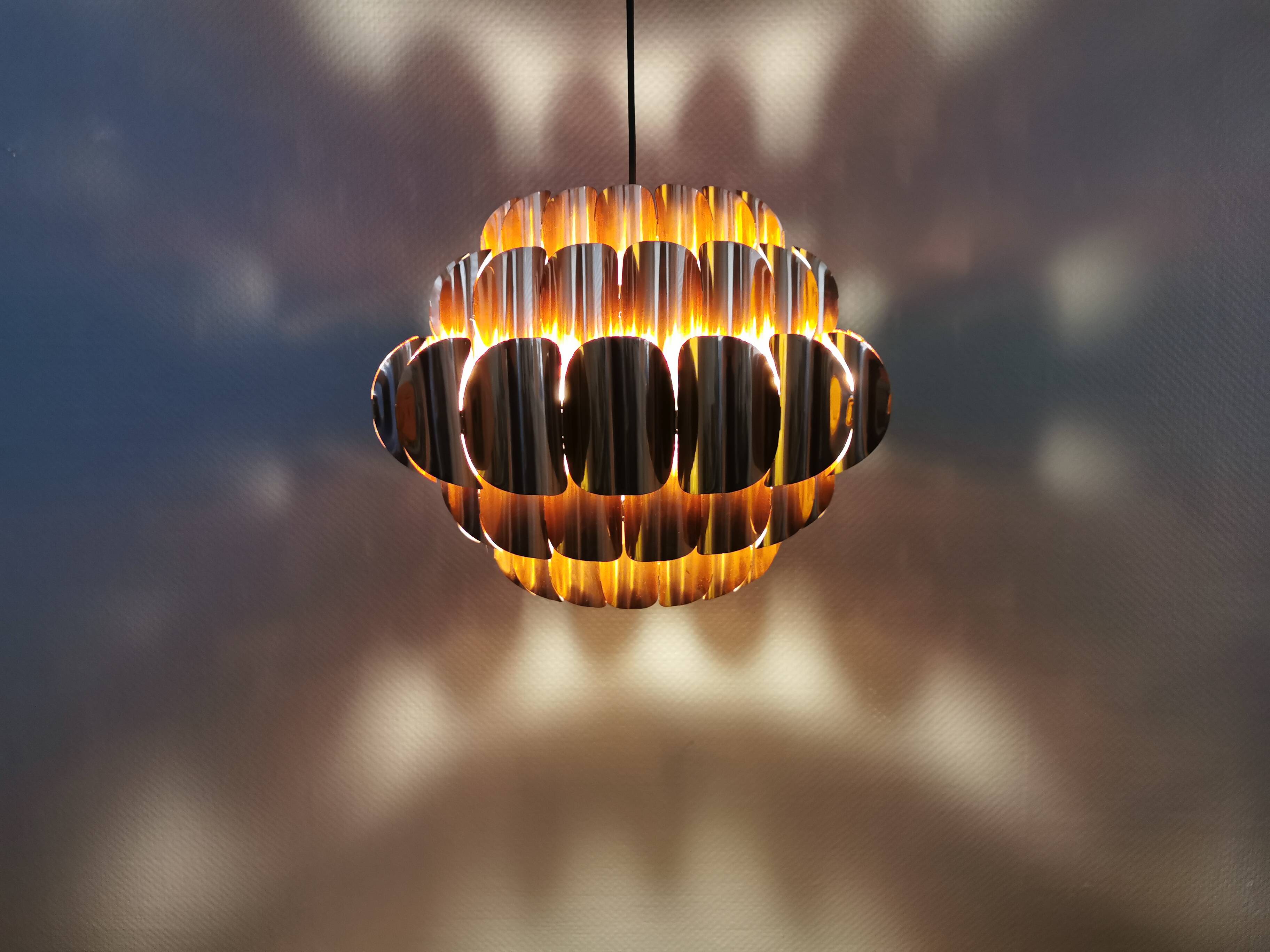 Copper colored hanging lamp. designed by thorsten orrling sweden