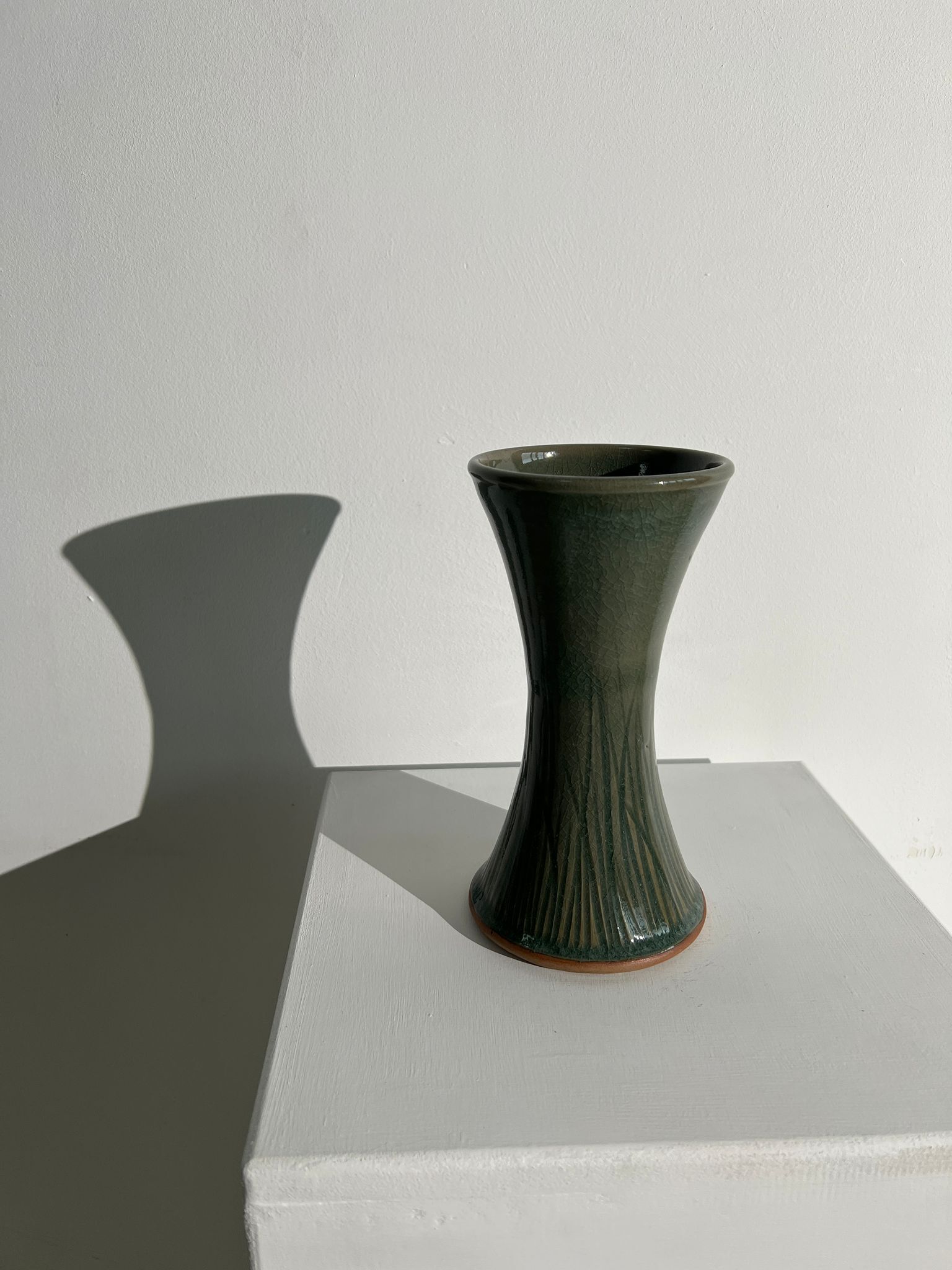 Dark green handcrafted vase with glazed ceramic grass blades