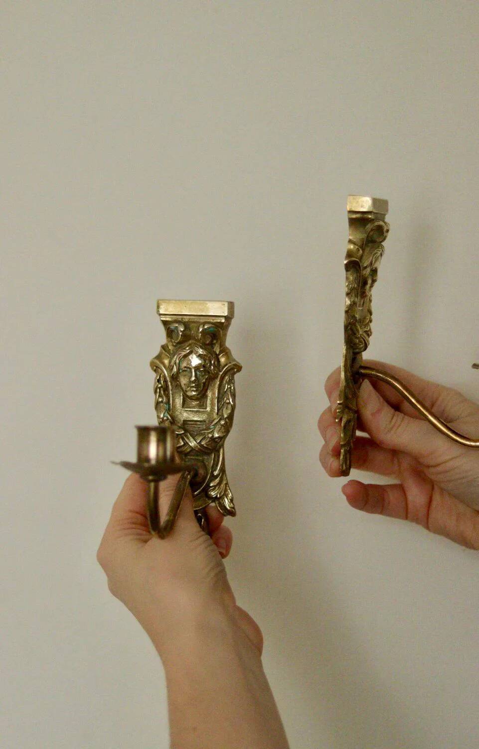 Pair of mid-century Swedish brass face motif sconces