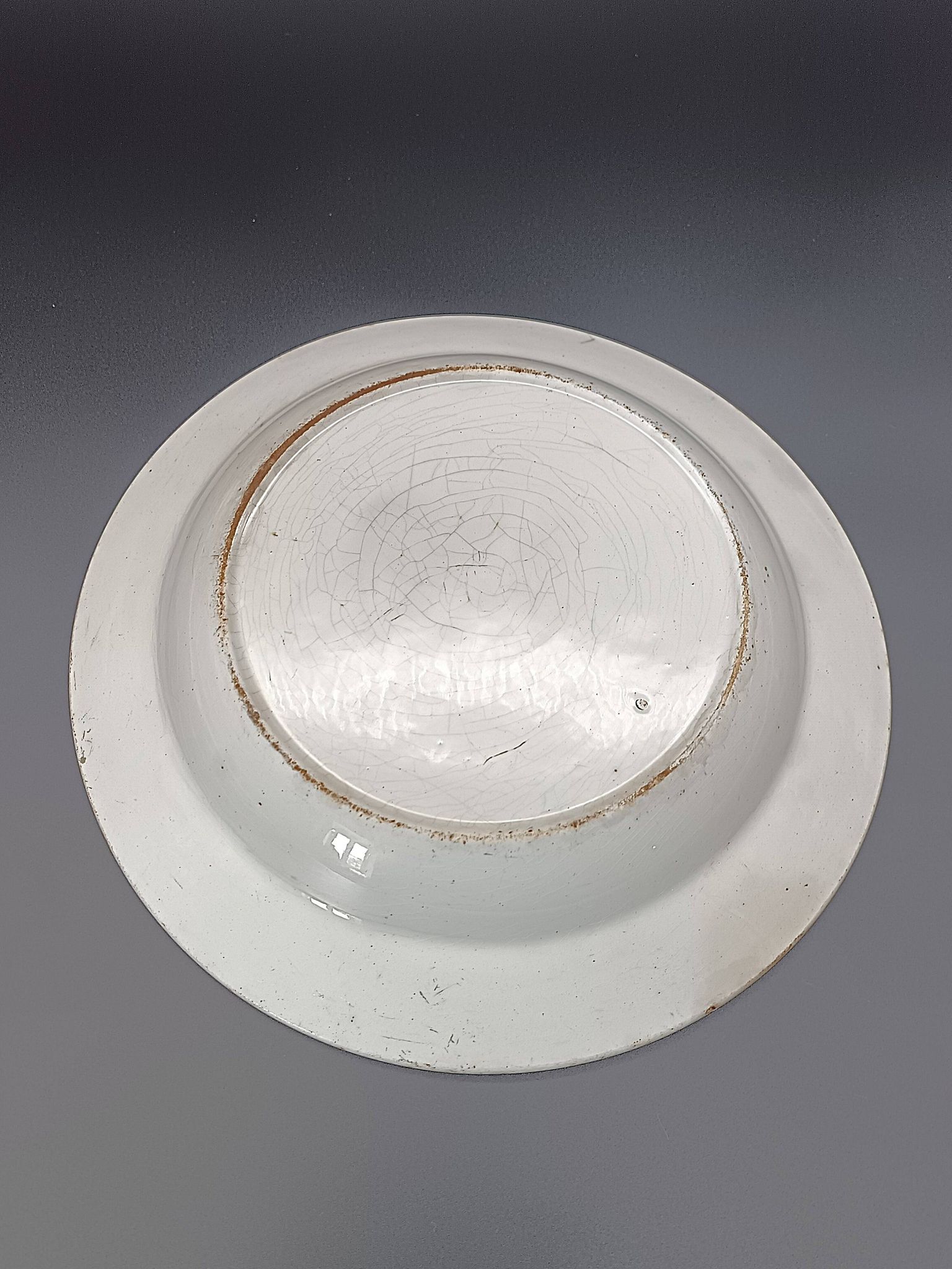 Large antique hollow dish from the 19th century, earthenware with pastoral decoration featuring a child, pig, and goose.