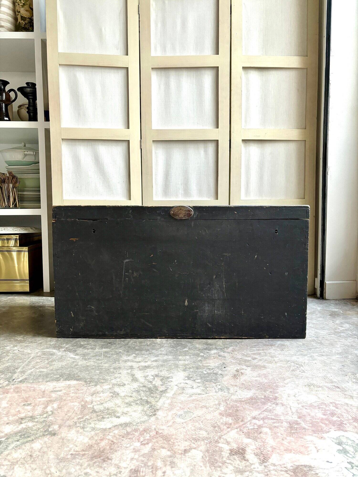 Trunk, black wooden chest and wallpaper
