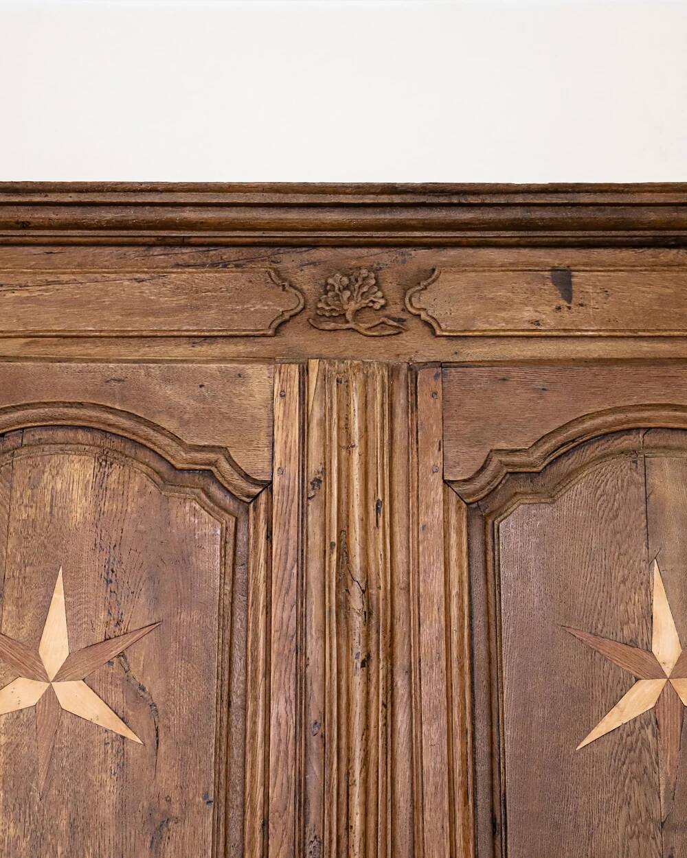 Antique French rustic wardrobe with star inlays.