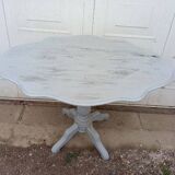 Reclining gray patinated oval pedestal table