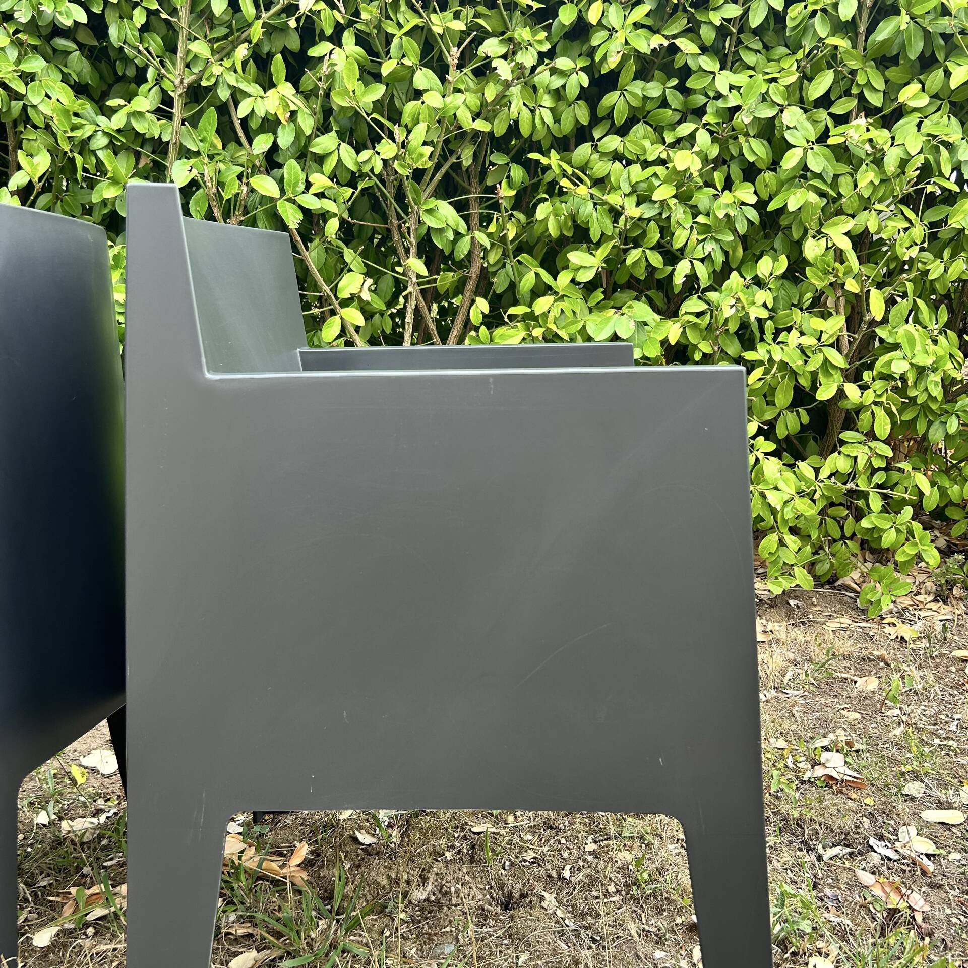 2 black Toy chairs designed by Starck