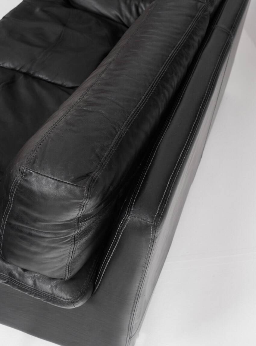 Black leather two-seater sofa. Roche Bobois edition. France, 1980s.