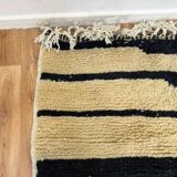 Handmade Moroccan rug in ecru with coloured patterns, 250cm x 150cm.