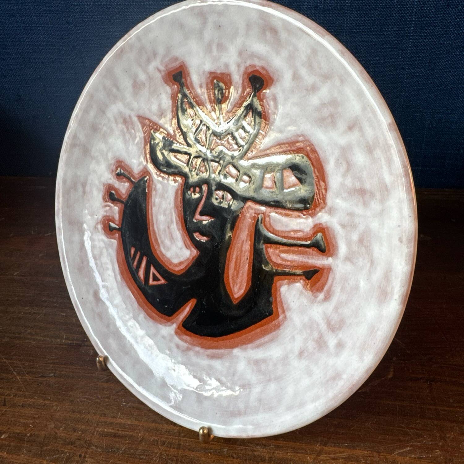 Terracotta plate, Jean Lurçat decorated with a character on a white background.