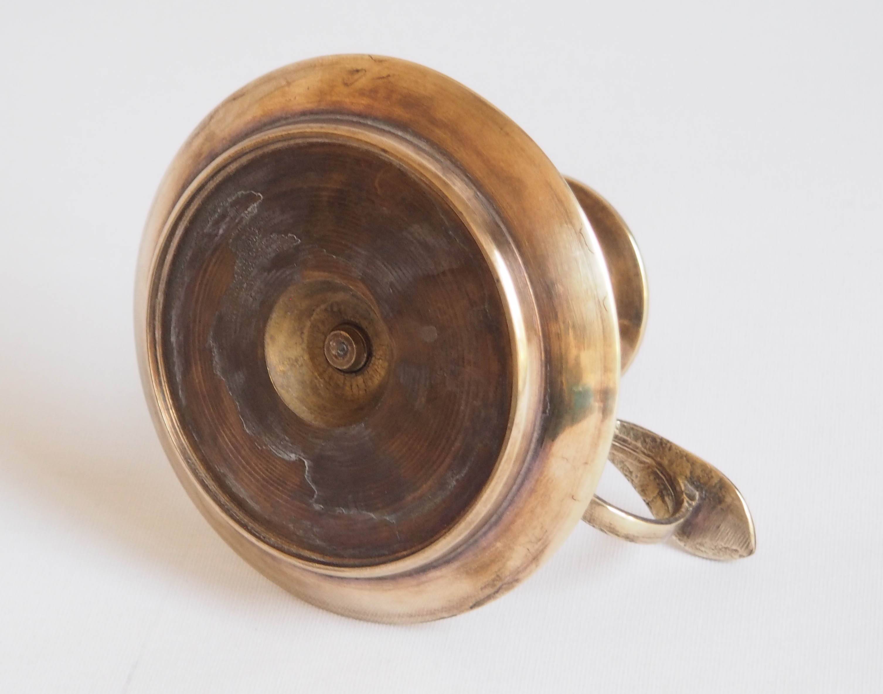 Brass candle holder with cup and handle