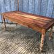Antique farmhouse table in solid cherry wood with turned legs.