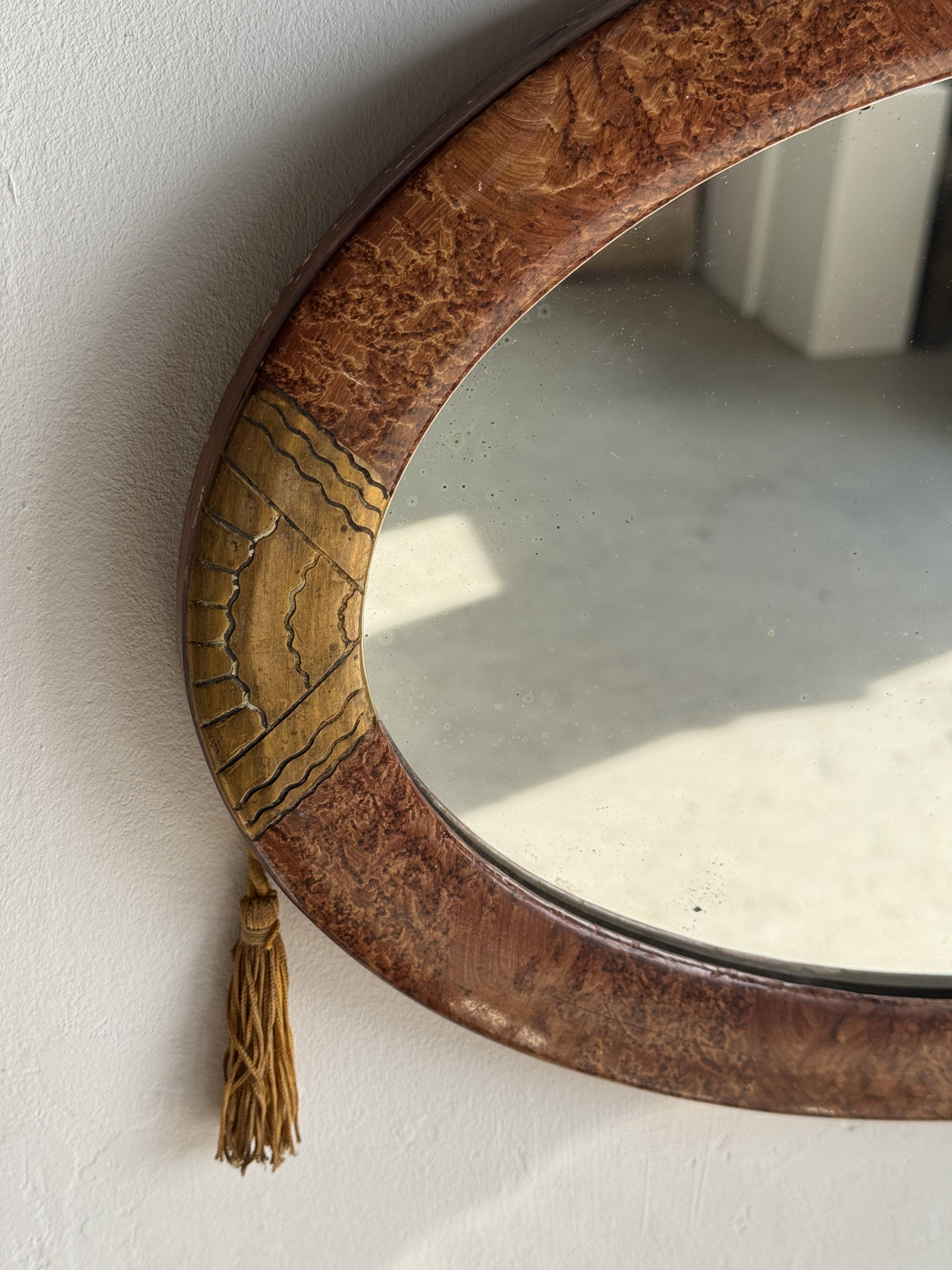 Small oval Art Deco mirror in brown and gold 33x54.