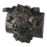 Carved lion head sculpture in stained wood