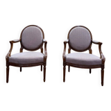 Pair of Louis XVI cabriolet armchairs with medallion backrest.