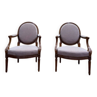 Pair of Louis XVI cabriolet armchairs with medallion backrest.