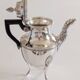 Empire-style silver-plated coffee pot with eagle head spout.