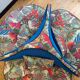 Round conversation sofa – blue velvet & parrot fabric – 140 cm