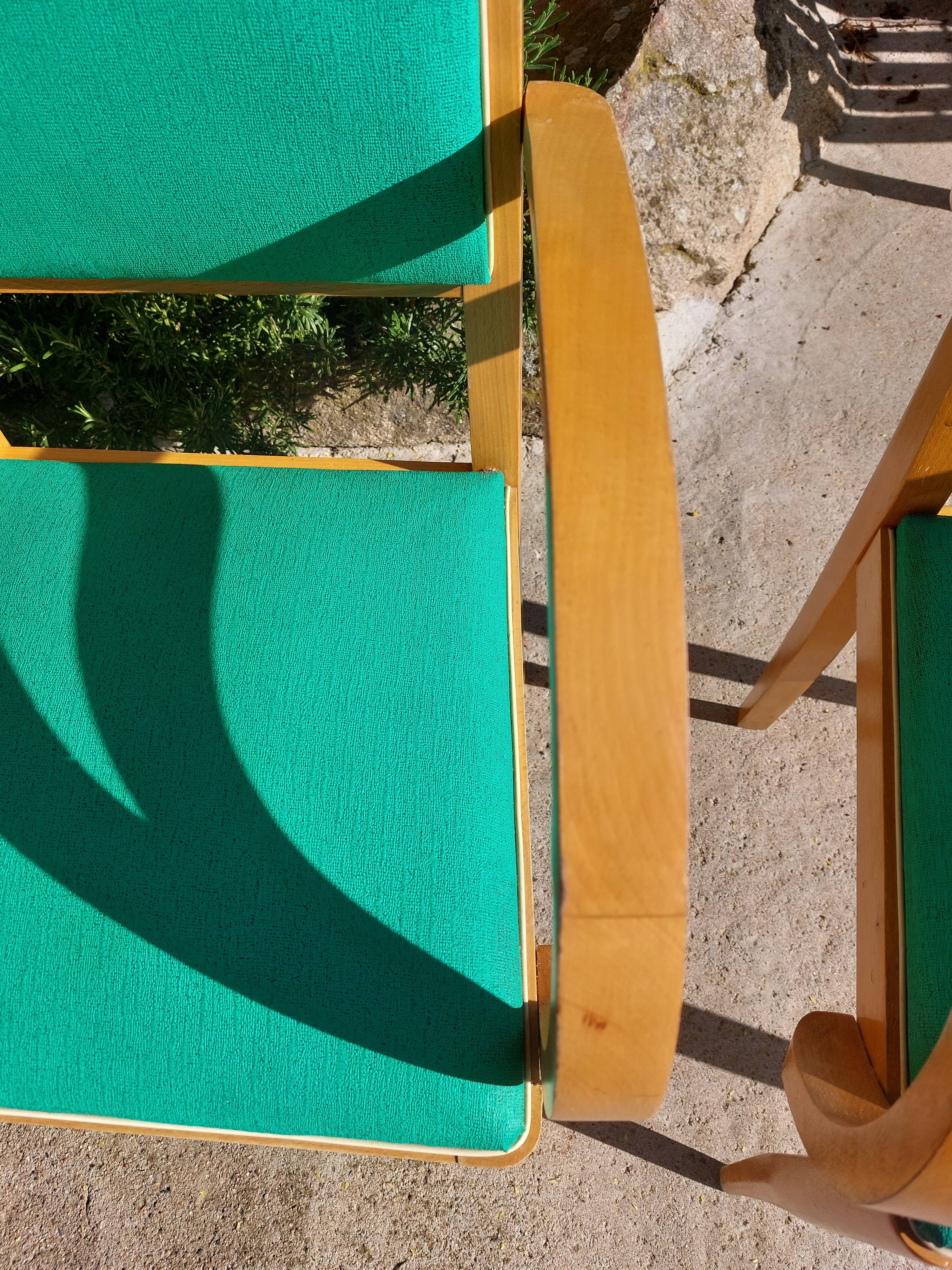 3 vintage bridge chairs with rounded armrests.