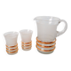 set composed of a pitcher and two large white granite glasses with gold edging from the 60s