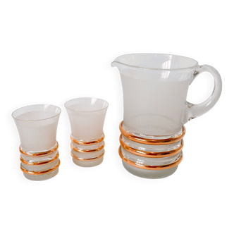 set composed of a pitcher and two large white granite glasses with gold edging from the 60s