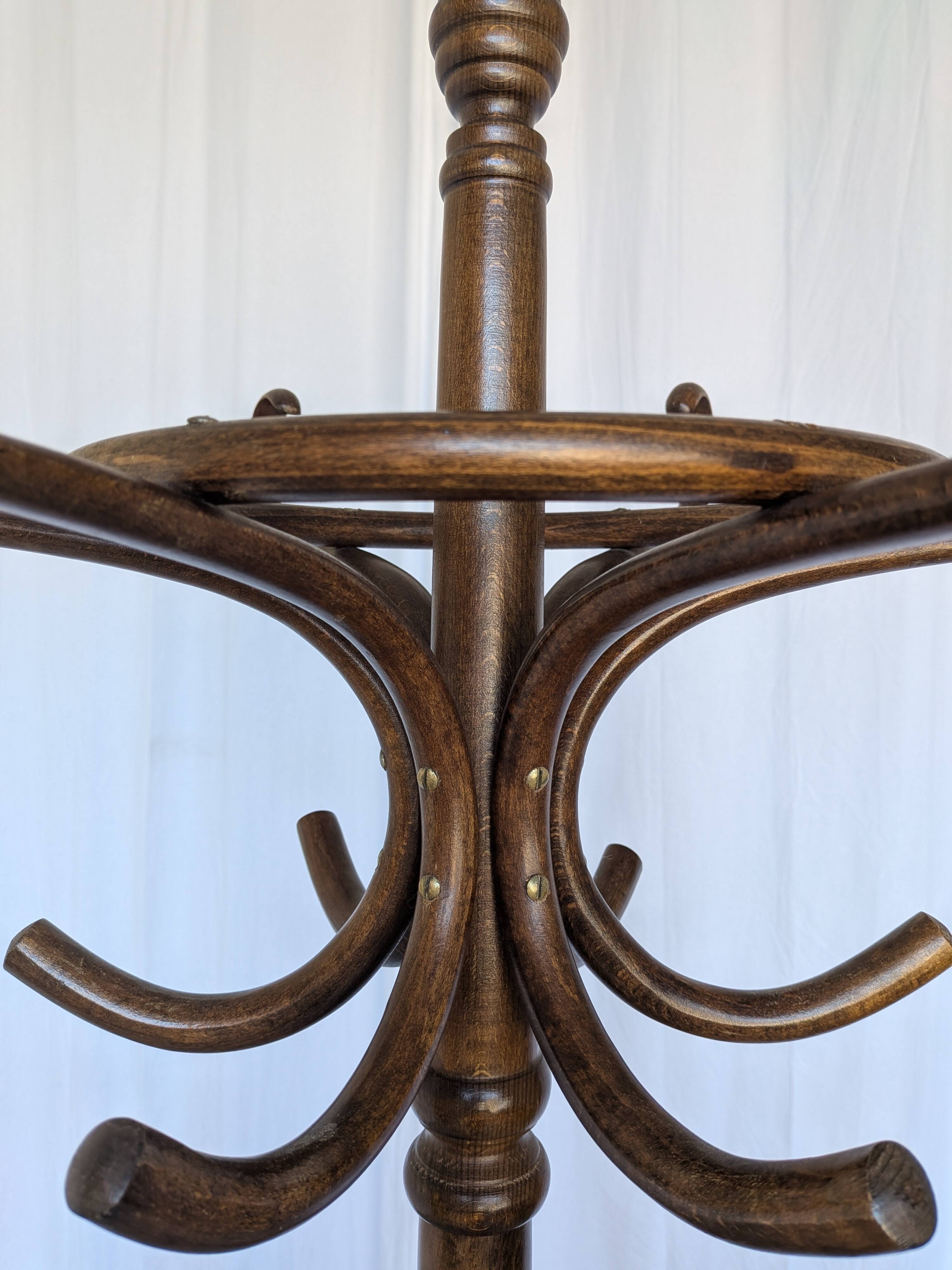Vintage bentwood coat rack in Thonet style / Dark wood coat rack with shadow.
