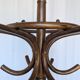 Vintage bentwood coat rack in Thonet style / Dark wood coat rack with shadow.