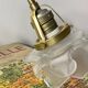 Swan neck wall light in brass with rose petal glass shade.