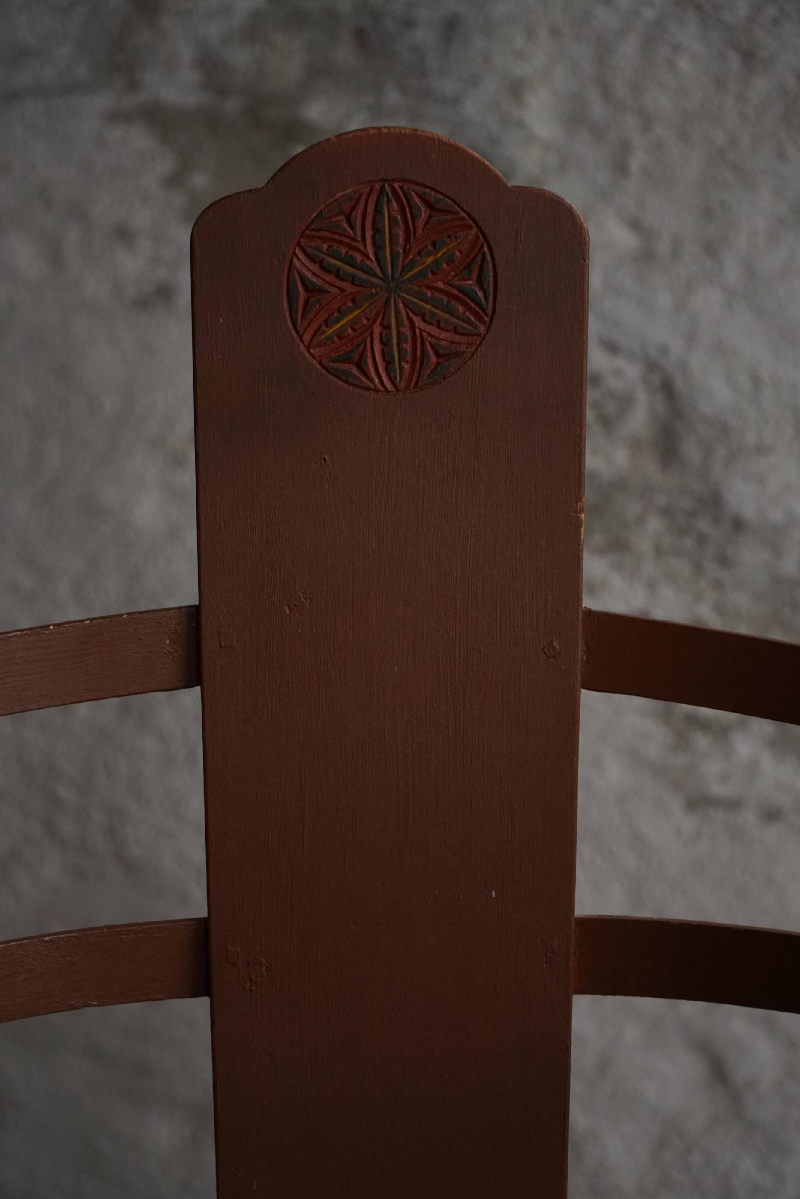 Pair of Scandinavian wooden armchairs with hand-carved folk motifs, 1920s.