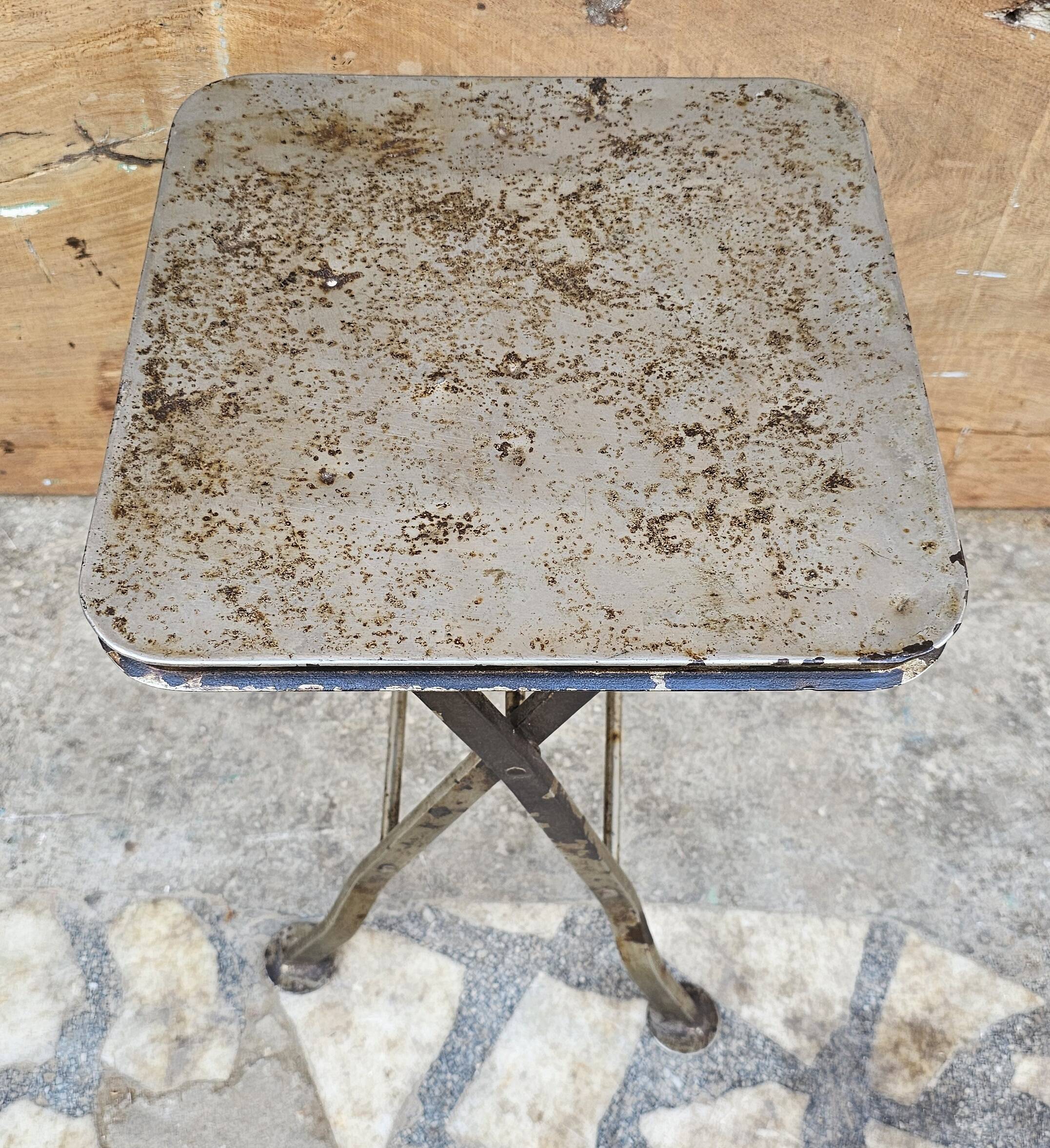 Old industrial folding steel stool