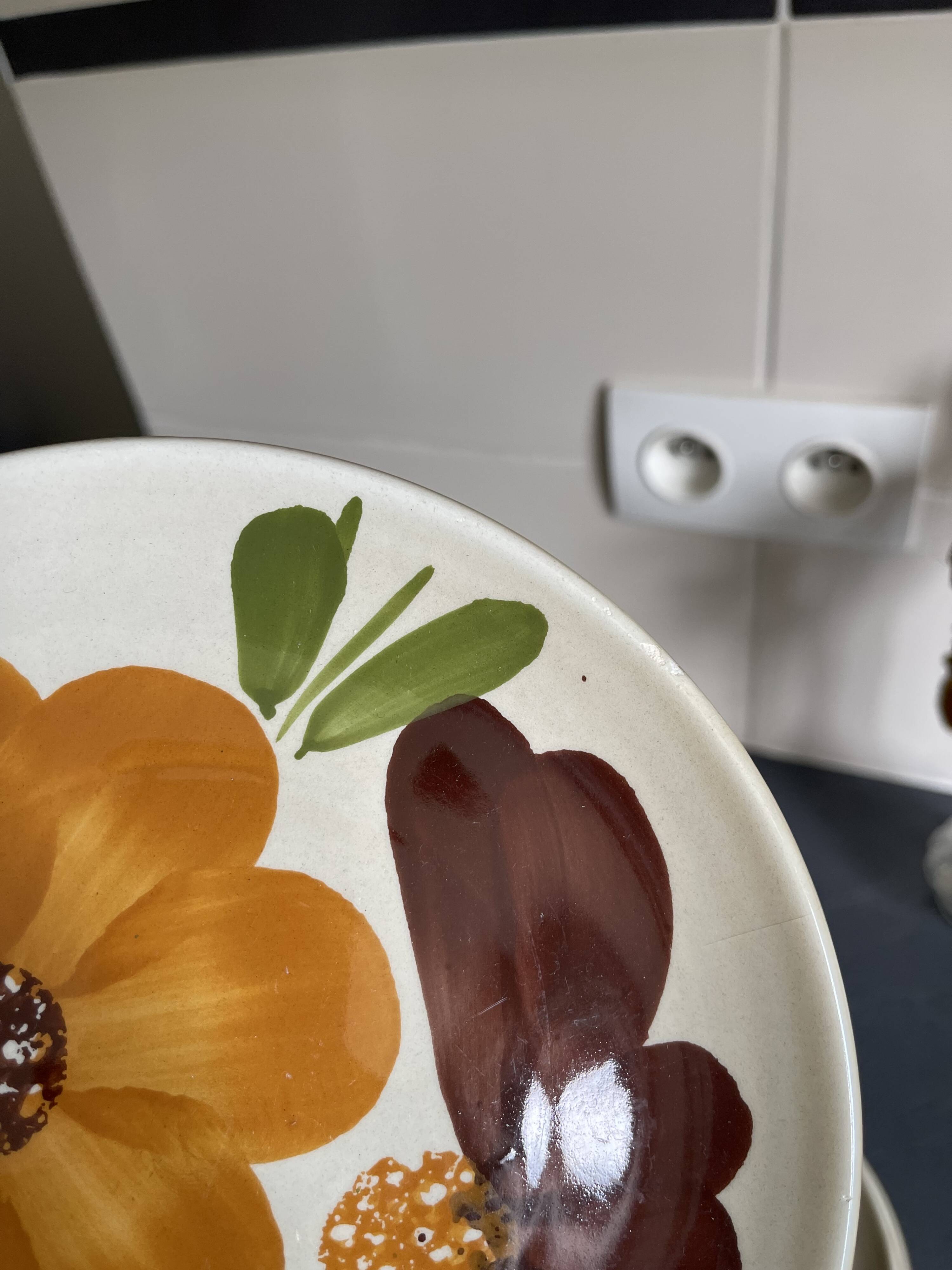 Italian ceramic plates with floral fruit designs.
