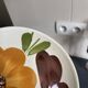 Italian ceramic plates with floral fruit designs.