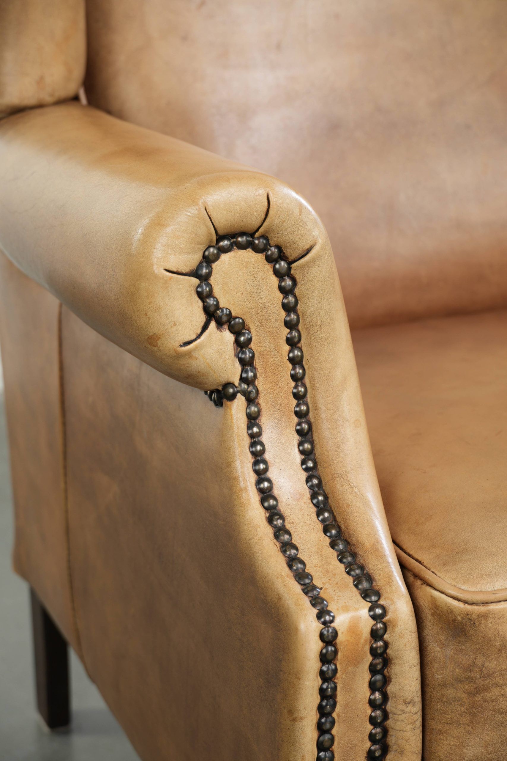 Comfortable cowhide wingback armchair with a timeless English look
