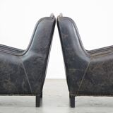 Set of 2 black cow leather armchairs finished with decorative nails, industrial style