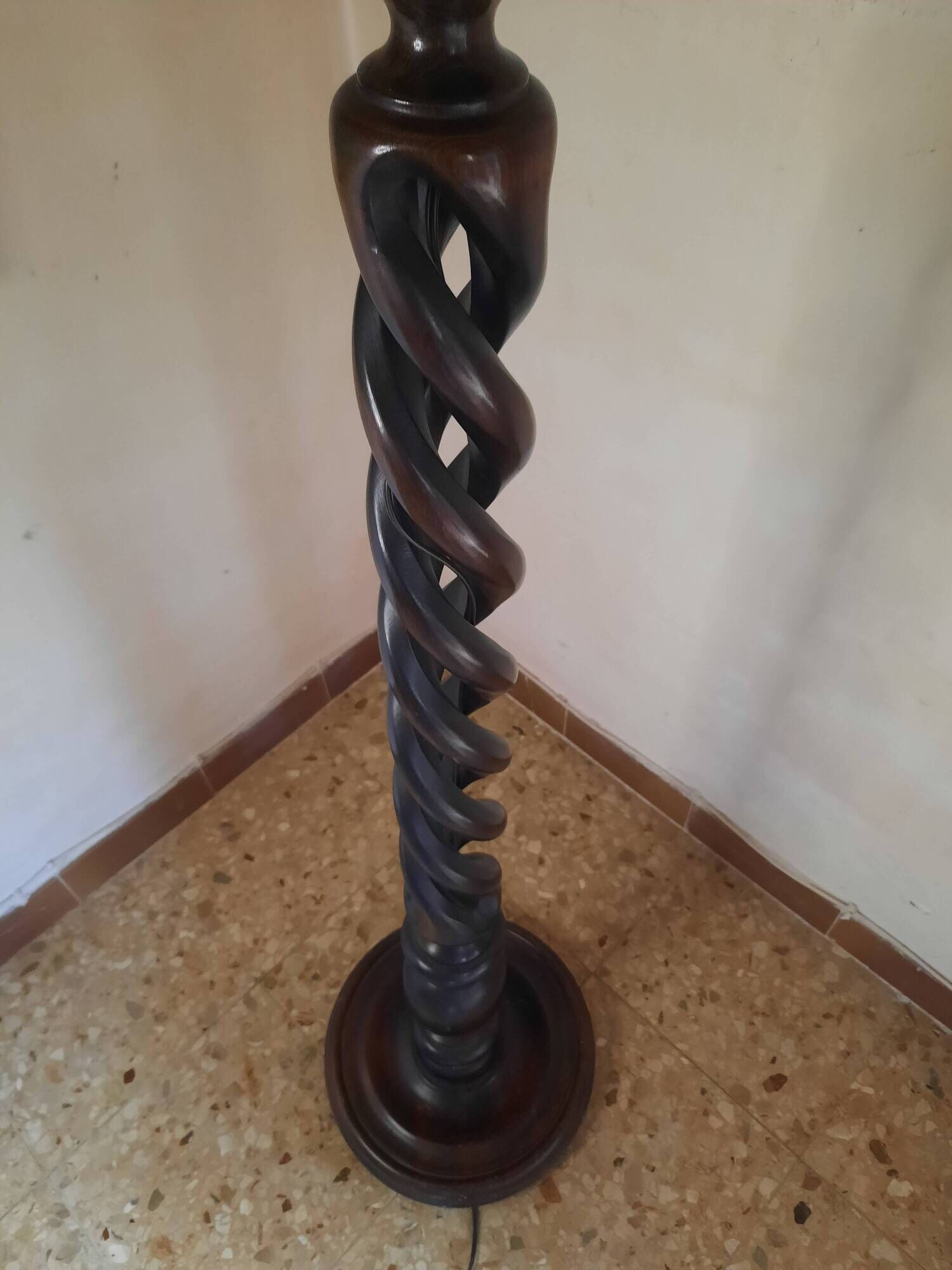 Sculptural floor lamp made of twisted turned wood.